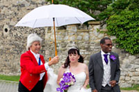 Lady Toastmaster carrying umbrella for Bride